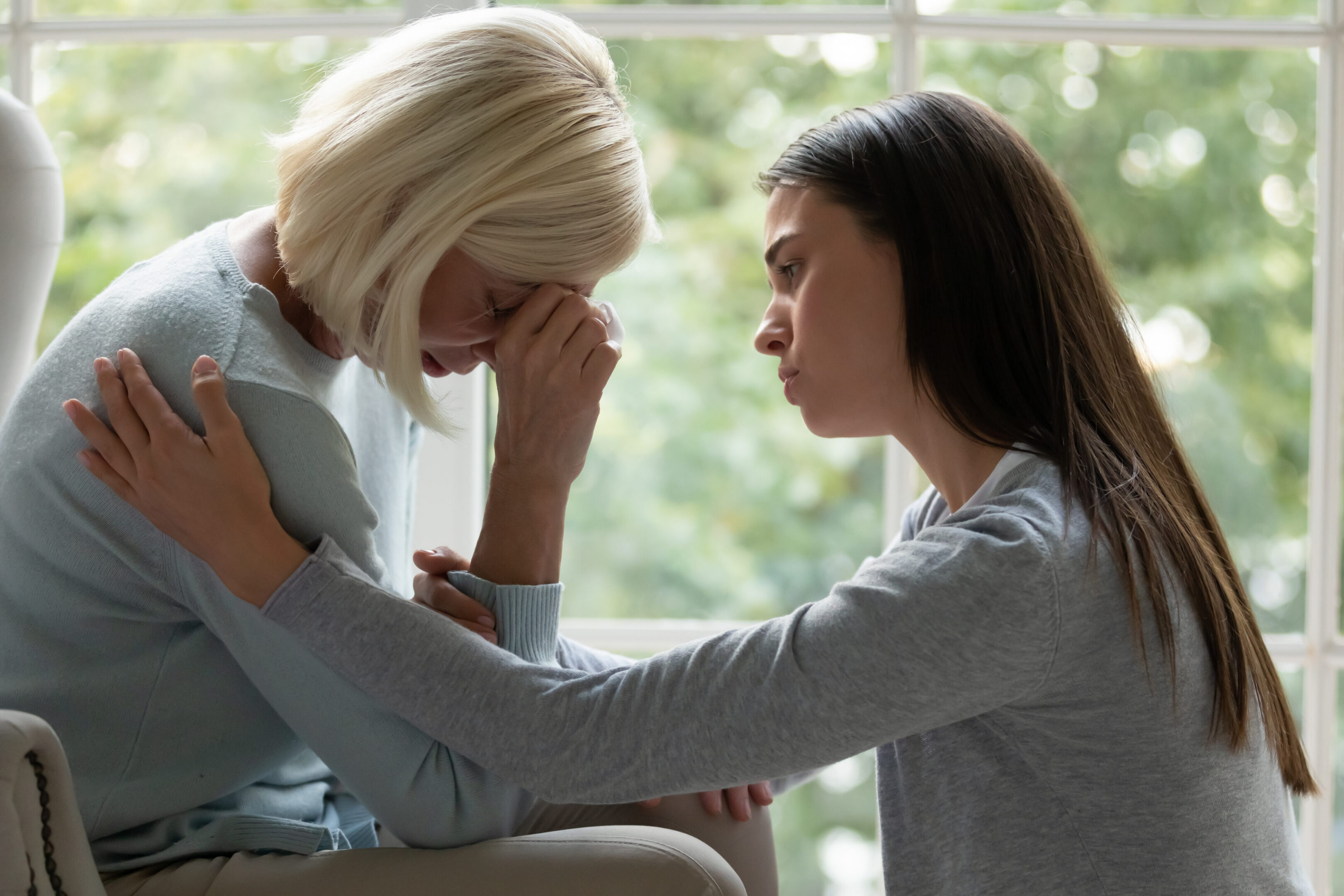 Woman comforting another woman in distress.