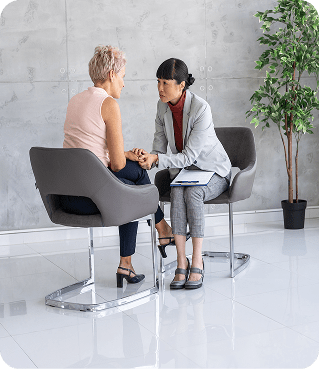Two women talking in modern office.
