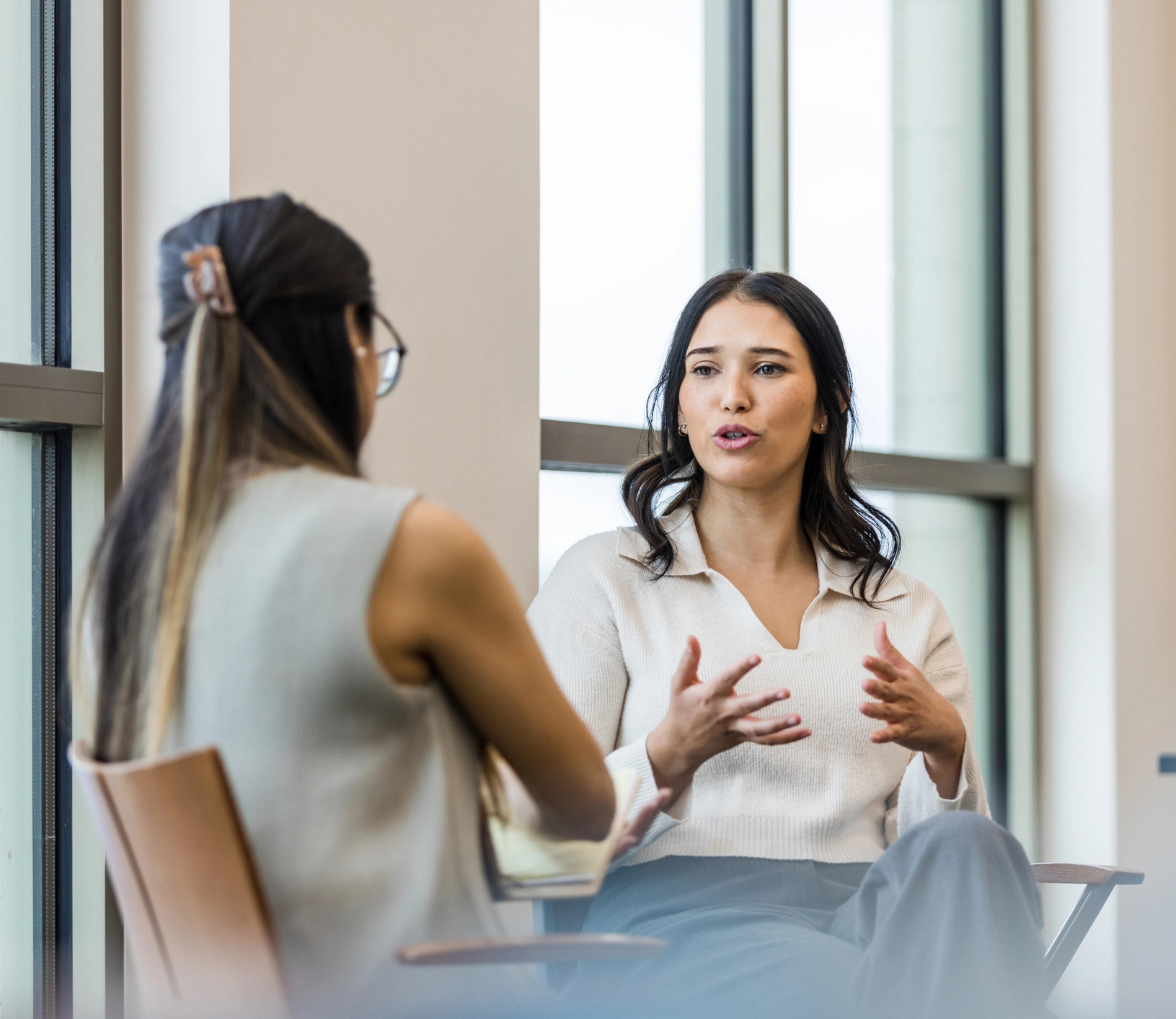 Two women in office having a conversation