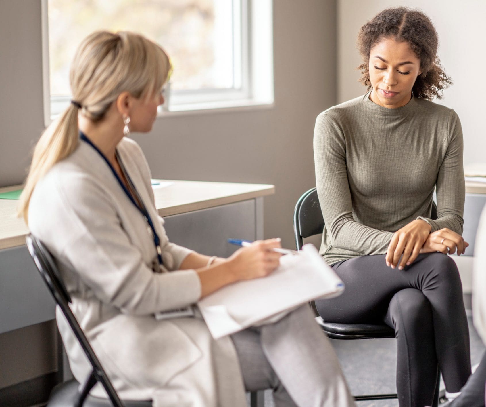 Woman receiving emotional support from therapist
