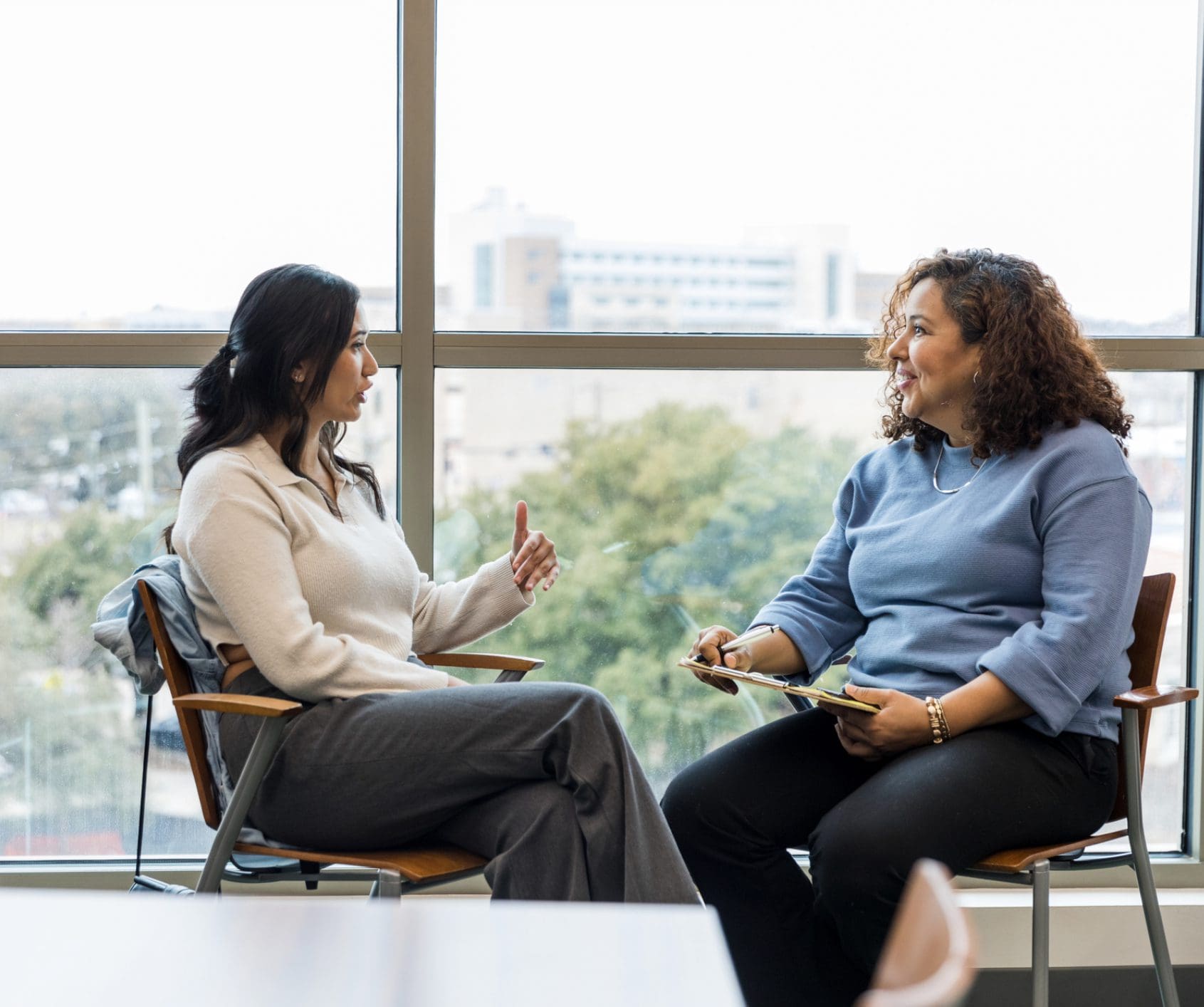 Two women in an office conversation