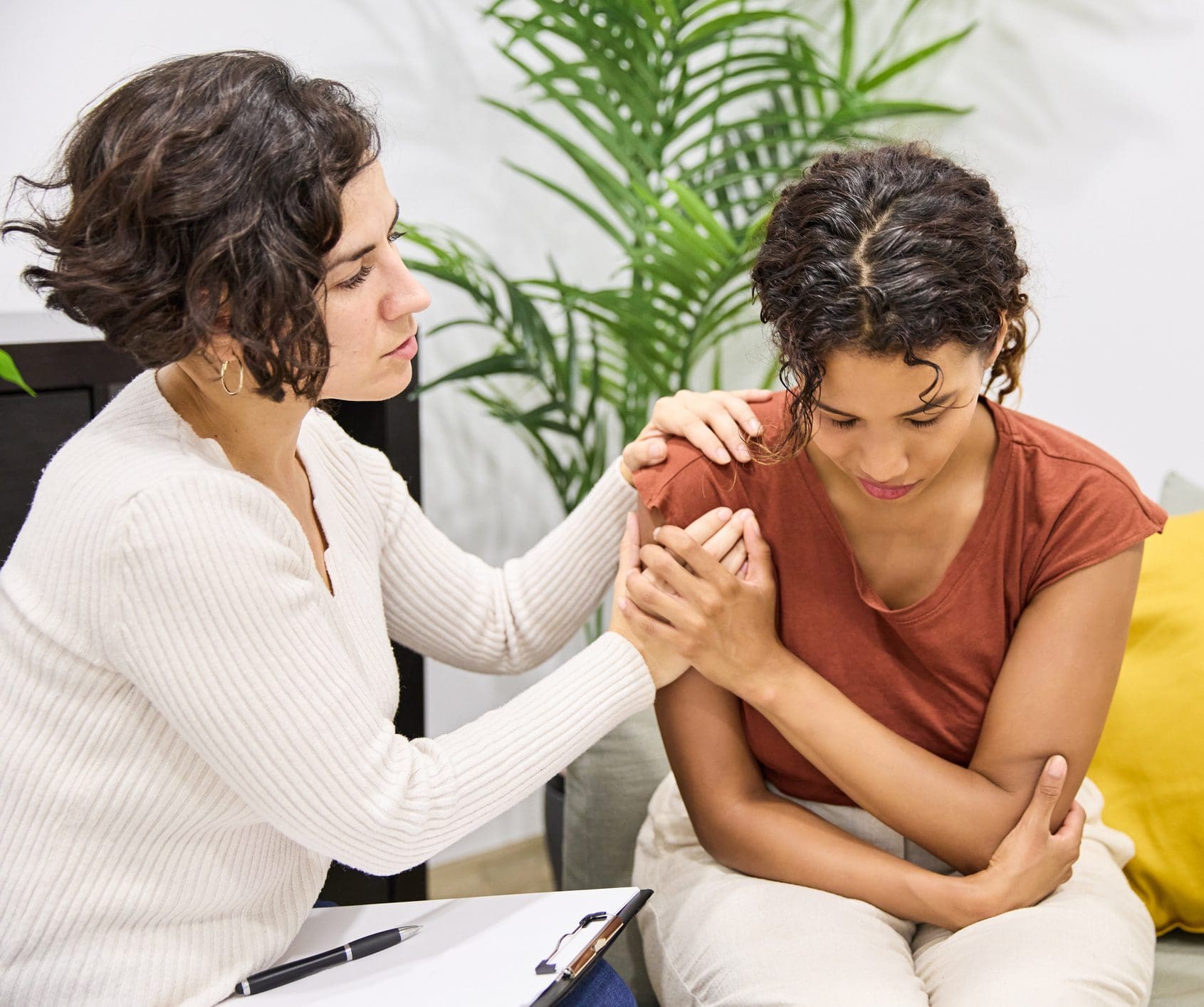 Therapist comforting upset woman during counseling