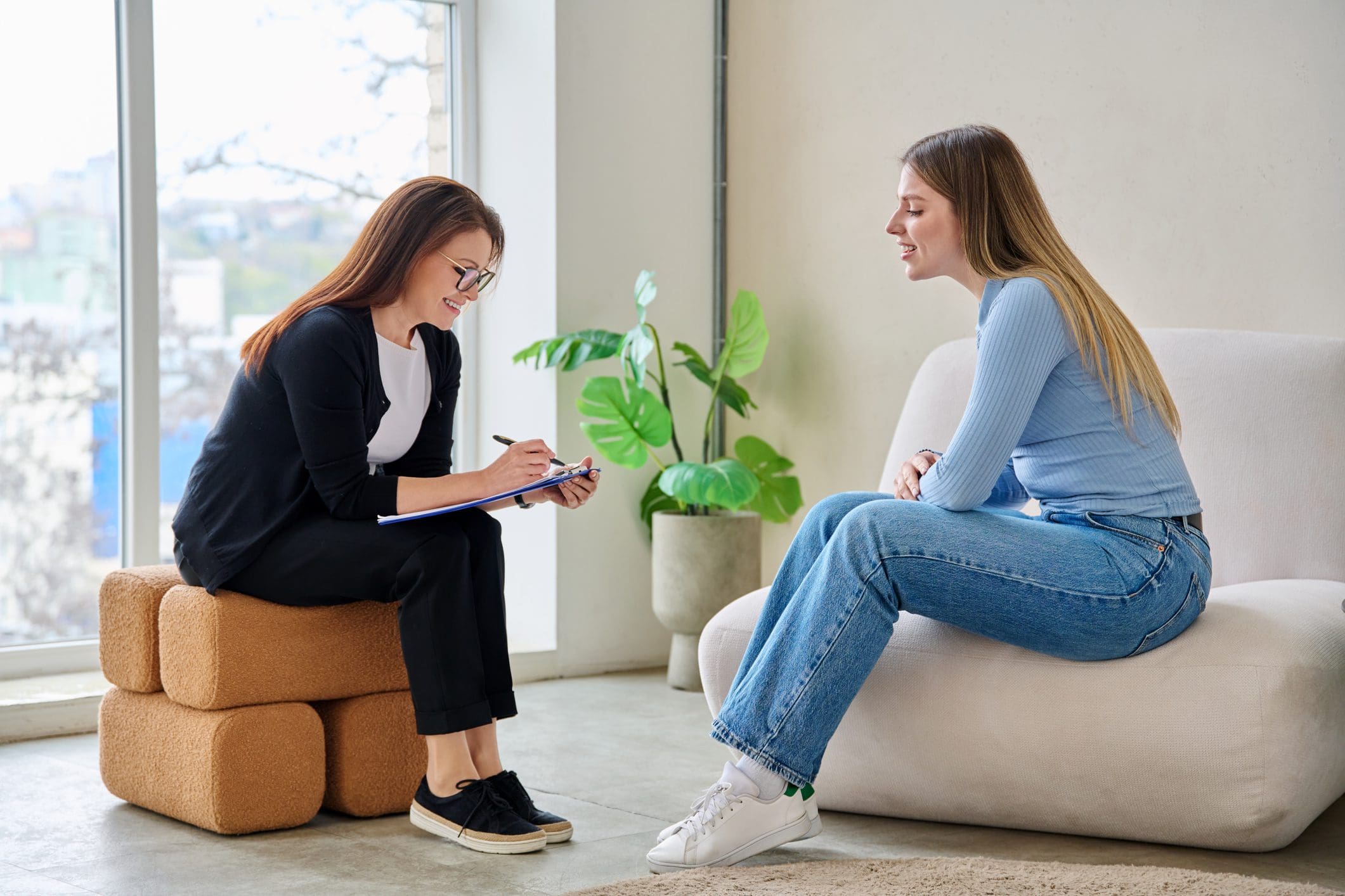 Therapist taking notes during counseling session