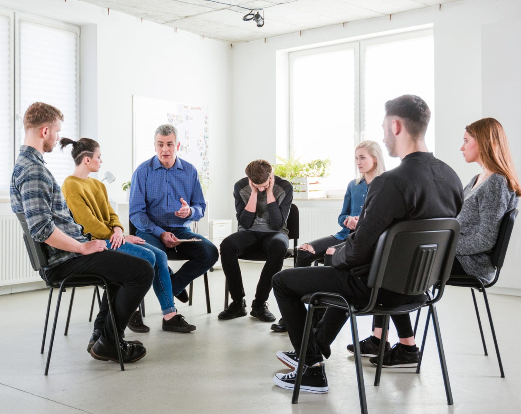 Support group therapy session with distressed participant