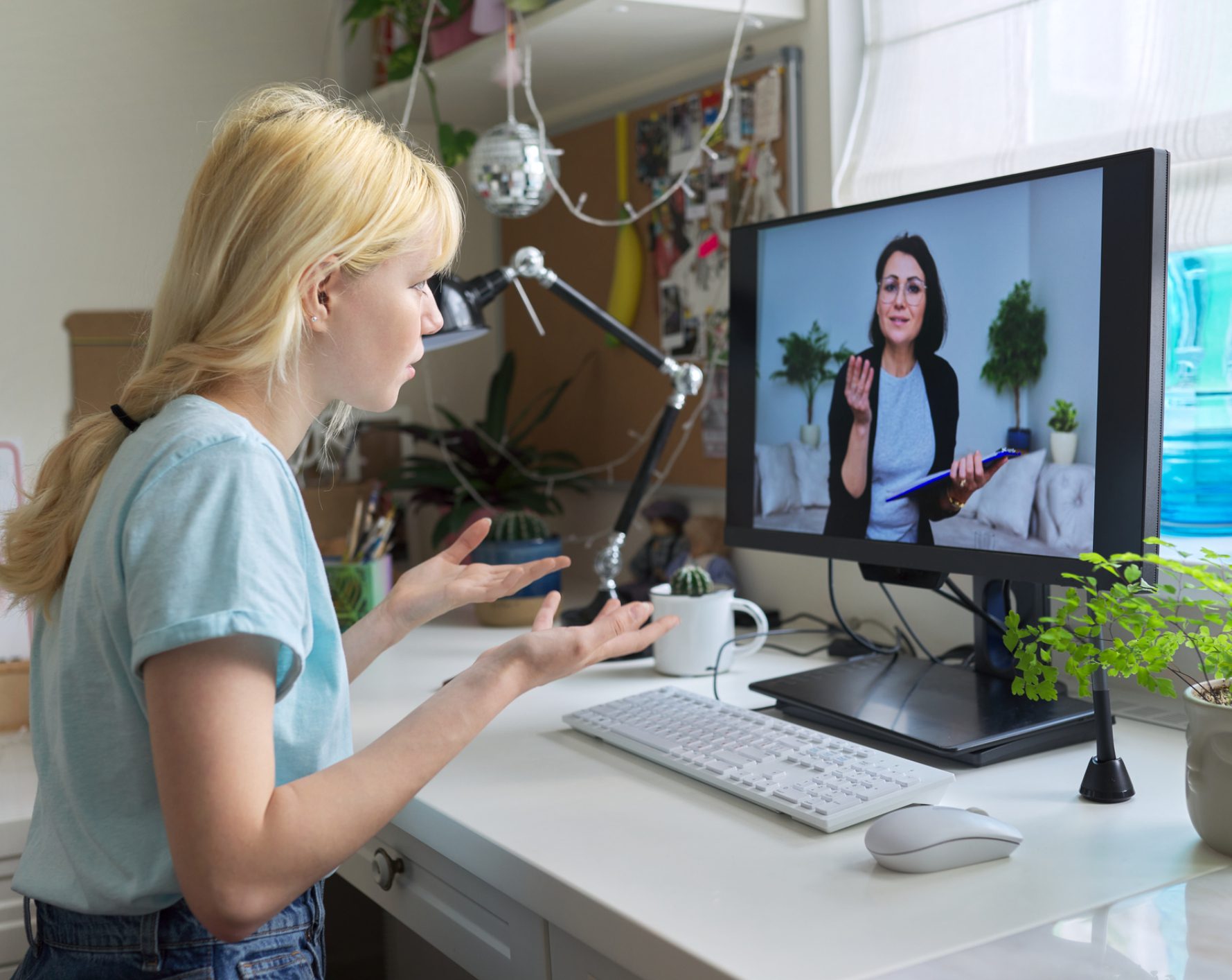 Girl video calling woman on computer monitor