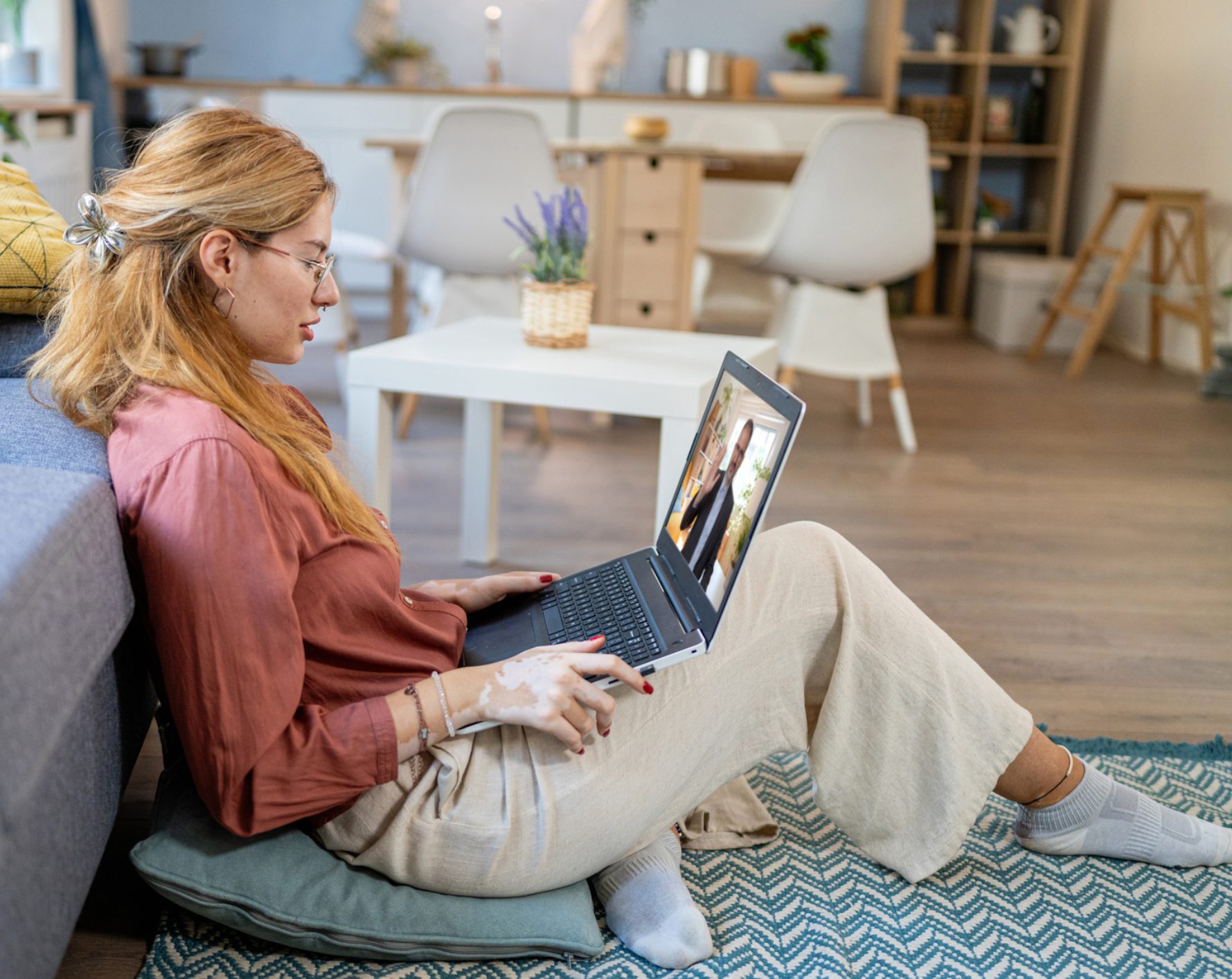 Woman video chatting on laptop at home