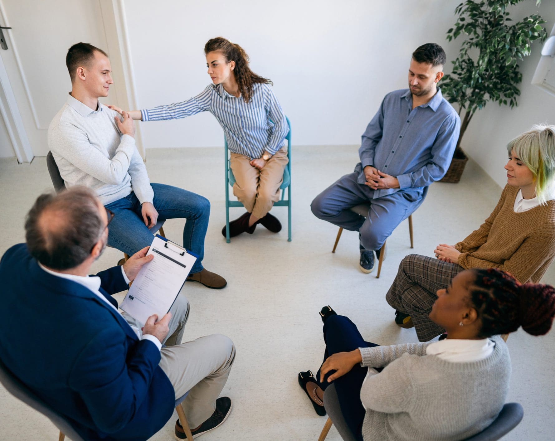 Group therapy session with participants sitting in circle
