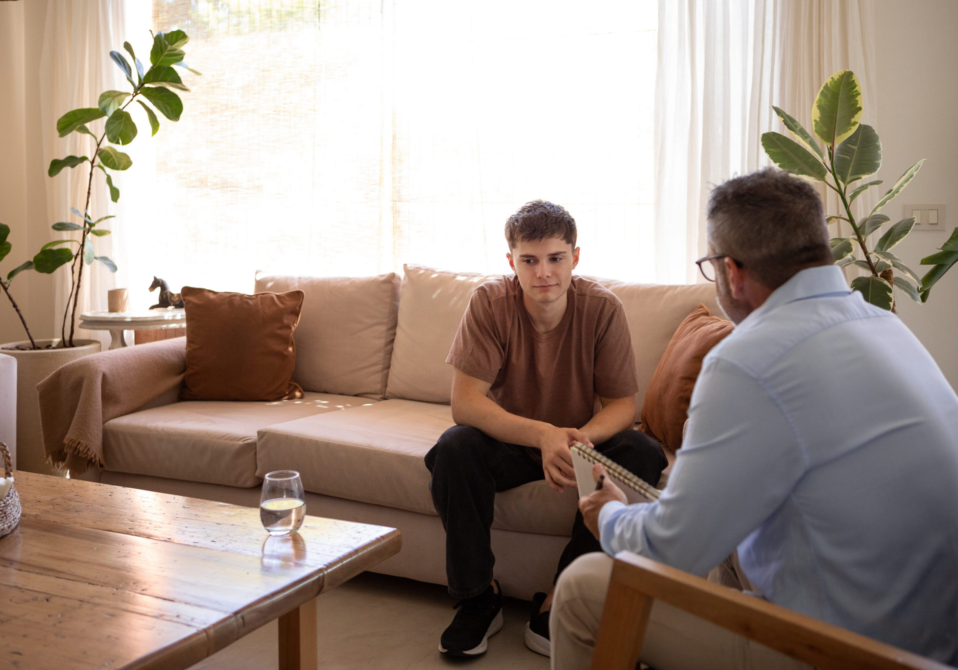 Two people talking in a living room.
